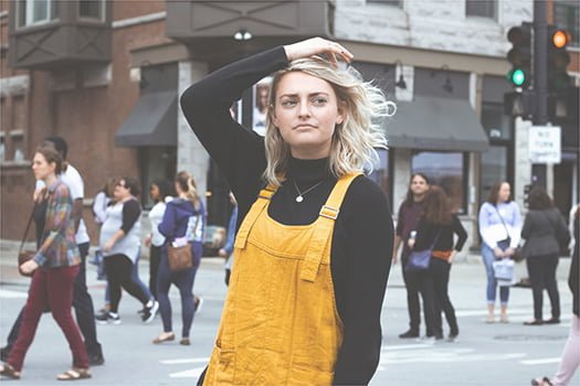 A woman who is an introverted solopreneur standing alone on a street.